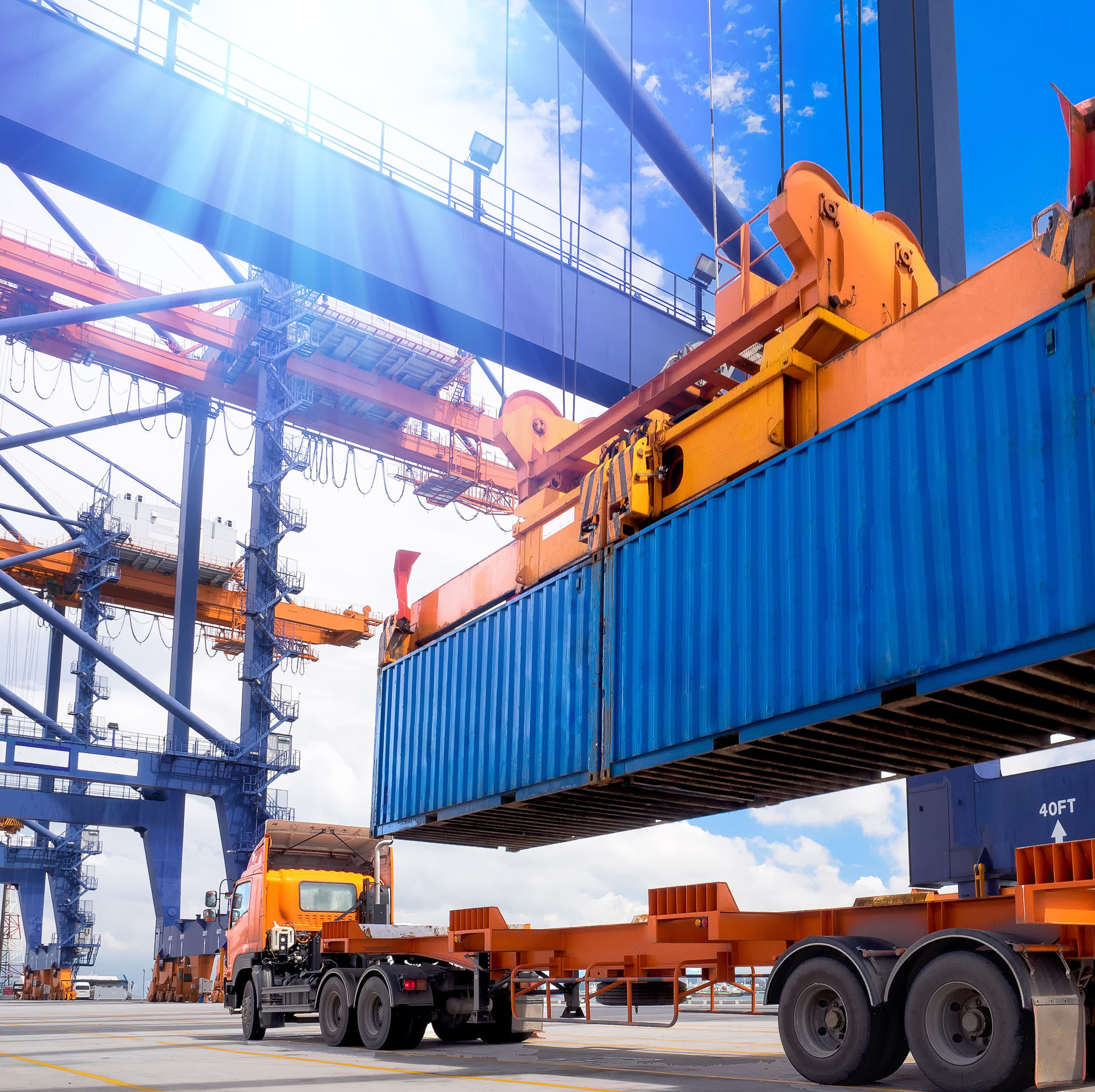 Industrial crane lifting up a shipping container