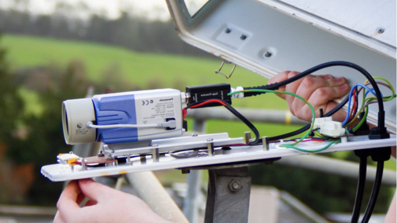 Close in shot of a Technical Installer installing a CCTV Camera